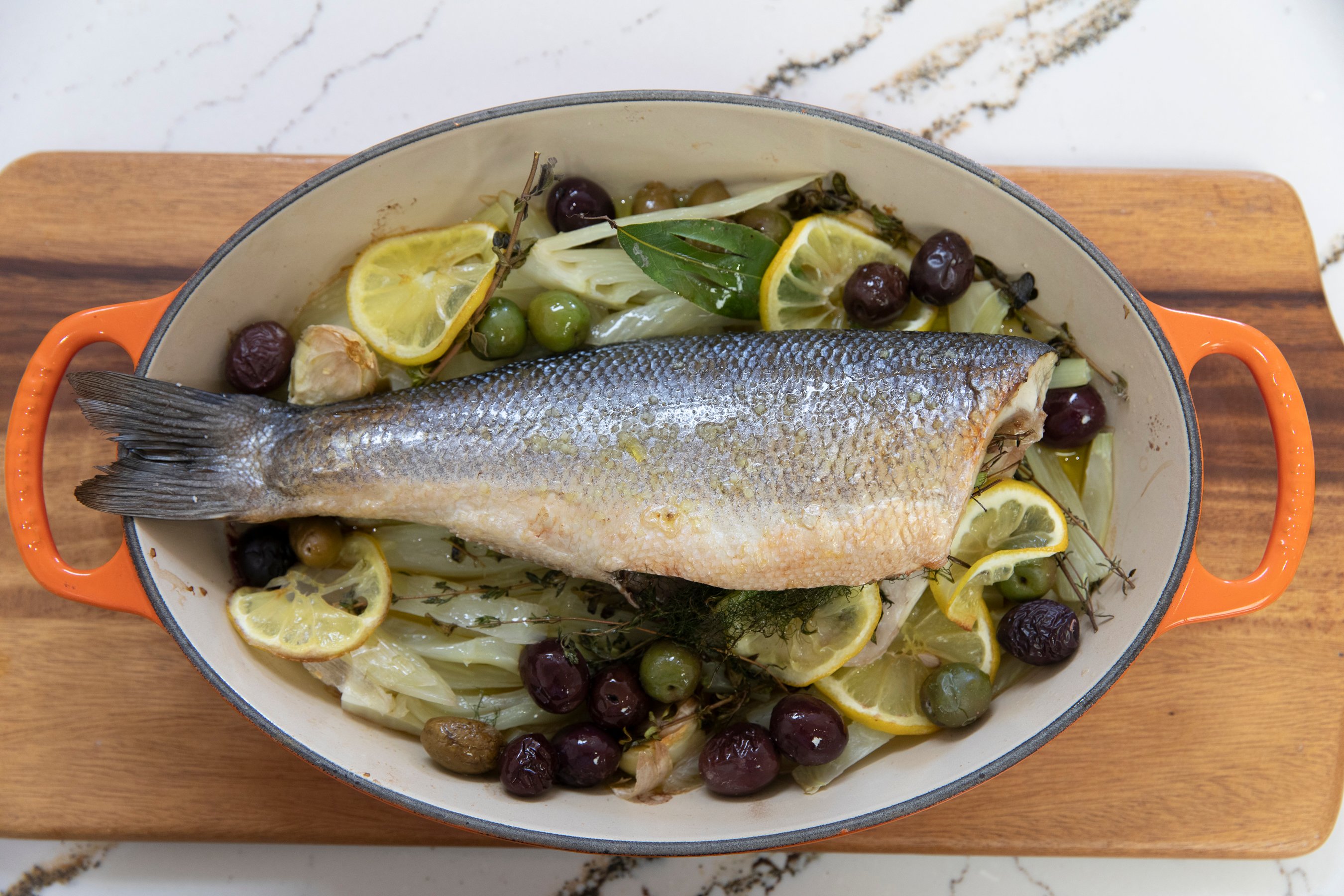 Whole roasted Bronzino with fennel, olives and lemon